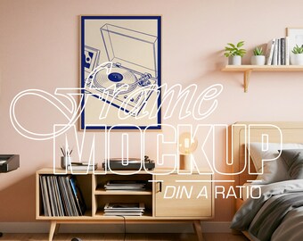 May include: A vertical rectangular wall art print featuring a blue line drawing of a record player on a cream background, enclosed in a thin wooden frame. The text "frame MOCKUP DIN A RATIO" is overlaid in white outline across the center.