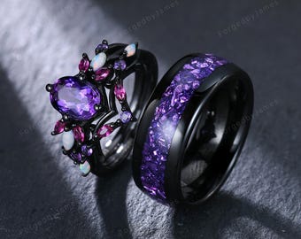 May include: A black ring set consisting of a band with a central purple crushed stone inlay and a matching ring featuring a large oval purple center stone surrounded by smaller marquise-cut purple stones and white opal accents in a black setting.