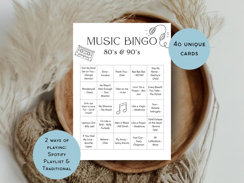 May include: A white Music Bingo game card with the text "Music Bingo 80's & 90's" and song titles. Includes 40 unique cards and 2 ways of playing: Spotify playlist & traditional. The card is on a wooden tray.