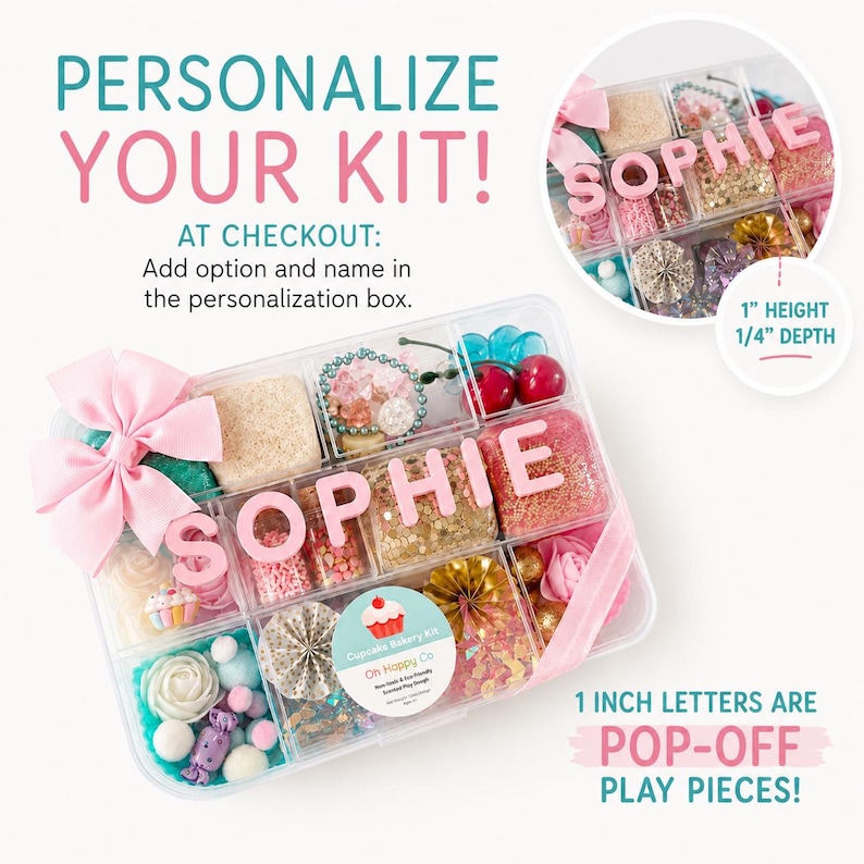 May include: A clear plastic organizer box filled with various craft supplies, including pink letters spelling SOPHIE, a pink bow, red cherry charms, gold paper fans, and a sticker labeled Cupcake Bakery Kit Oh Happy Co. The letters are 1 inch high.