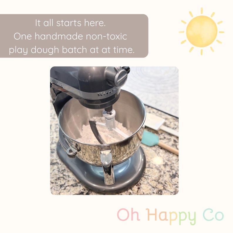 May include: A gray KitchenAid stand mixer with a stainless steel bowl, filled with flour. The image includes text that reads "It all starts here. One handmade non-toxic play dough batch at a time."