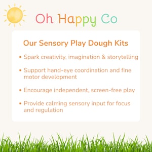 May include: A white rectangular sign with a yellow sun icon and the text Oh Happy Co. The text Our Sensory Play Dough Kits is followed by a bulleted list detailing benefits including creativity, hand-eye coordination, independent play, and sensory input.