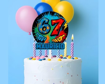 May include: A white frosted cake with colorful sprinkles and a cake topper that reads "67 MAURICIO". The cake is decorated with lit candles and surrounded by pink, blue, and yellow balloons. A festive birthday cake.