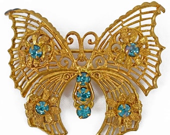 Vintage Goldtone filigree broche de mariposa con piedras azules facetadas
