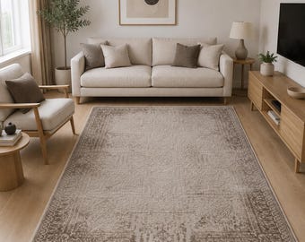 May include: A rectangular area rug featuring a faded, distressed pattern in shades of beige, taupe, and cream. The design includes a central medallion motif surrounded by intricate, ornate borders that cover the entire surface of the floor covering.