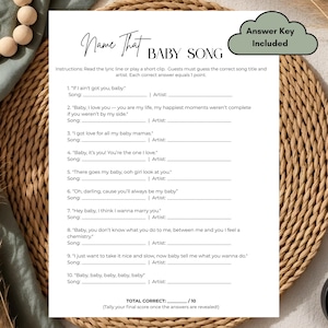 May include: A black and white baby shower game sheet titled "Name That Baby Song." The game includes song lyrics with spaces for song titles and artist names. An "Answer Key Included" cloud-shaped graphic is in the upper right corner.