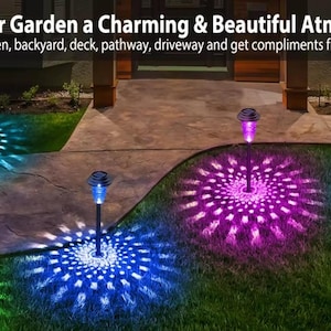 RGB solar lights casting green, blue, and purple burst patterns on a patio and lawn at night