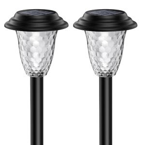 Two black solar stake lights with clear petal-pattern lampshades on a white background