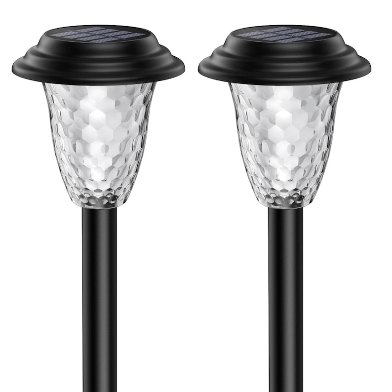 Two black solar stake lights with clear petal-pattern lampshades on a white background