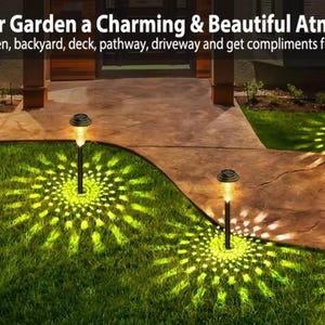 Solar garden lights illuminating a curved driveway and lawn pathway with warm yellow-green glow