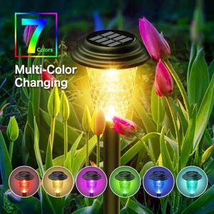 Solar stake light in warm white mode glowing among tulip flowers, showing 7 available color options