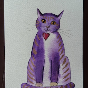 May include: Watercolor painting of a purple cat with gold stripes and a red heart. The cat is sitting upright with its tail curled. The cat's eyes are yellow, and the painting is on white paper.