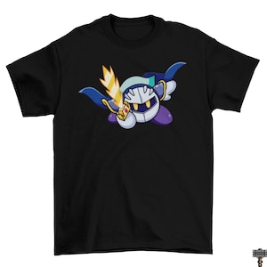 May include: Black t-shirt featuring a cartoon character with a white helmet, yellow sword, and blue cape. The character has a white body, purple feet, and a yellow and blue face. The design is centered on the front of the shirt.