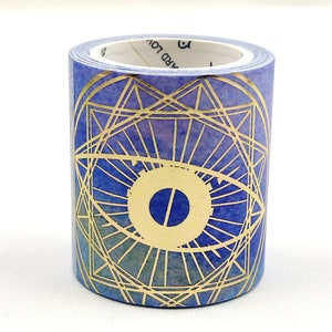 May include: Washi tape roll with a gold geometric eye design on a blue and purple background. The cylindrical tape is unused, with a white interior. Suitable for scrapbooking and crafts. The tape is approximately 1.5 cm in diameter.