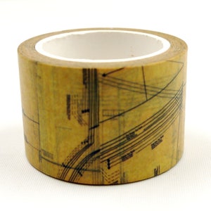 May include: A roll of decorative washi tape with a vintage map design. The tape has a tan background with black lines and text, and a white inner core. Suitable for scrapbooking and crafts.