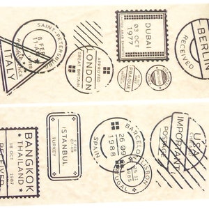 May include: A brown paper tape dispenser with black and white stamps featuring city names and dates. The stamps include "Bangkok, Thailand", "Berlin, Germany", "Istanbul, Turkey", "Dubai", "London", "Saint Petersburg", "Argentina", "USA", "Spain", "Barcelona", "Lisbon", "Italy", "Sydney, Australia".