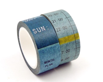 May include: Two rolls of washi tape with a blue and gray color scheme. One roll is labeled "SUN:" and "MONTH PLAN." The other roll displays time increments from 7:00 to 22:00, with a yellow horizontal line.
