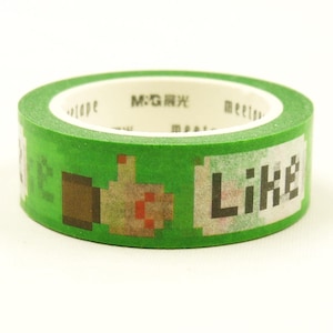 May include: A roll of green washi tape featuring a repeating pixelated graphic of a thumbs-up icon and the word Like in a black pixel font. The inner core of the tape roll displays the text M:G and meetape printed in black on a white background.