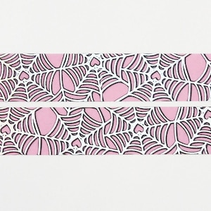 May include: Pink and white washi tape with a black spiderweb pattern and small hearts.