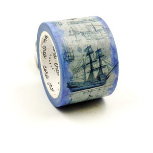 May include: A roll of decorative washi tape with a blue watercolour wash design and illustrations of vintage sailing ships. The tape has the text "cora crea crafts" printed on the side.