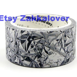 May include: A roll of decorative tape with a crumpled silver foil texture. The tape has a white inner core with the text "have a good day" and other characters. The Etsy shop name "Etsy Zakkalover" is written in blue.