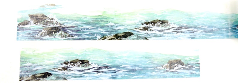 May include: A watercolor painting of a seascape with blue water and dark gray rocks. The water is choppy and there are whitecaps on the waves. The rocks are scattered throughout the water.