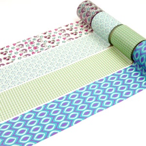 Könnte beinhalten: Vier Rollen dekoratives Klebeband in einer Reihe angeordnet. Die Muster umfassen ein geometrisches Rauten-Design in Lila und Türkis, ein kleines grünes Wiederholungsmuster, ein hellblaues Blumenmotiv und ein weißes Band mit Regenbogen-Symbolen.
