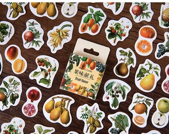 May include: A sheet of colorful fruit stickers with a variety of fruits, including apples, pears, oranges, grapes, and pineapples. The stickers are on a wooden background. The text on the sticker box reads "Fruit Flavor".