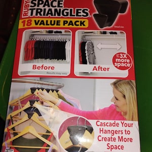 May include: A red and yellow box for "RUBY Space Triangles" with the text "Triple Your Closet Space!" and "18 VALUE PACK." The box shows before and after closet space comparisons. Includes 18 Space Triangles and an instruction manual.