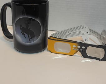 End of the Trail" rodeo mug alongside protective eclipse glasses from the August 21, 2017 solar eclipse.