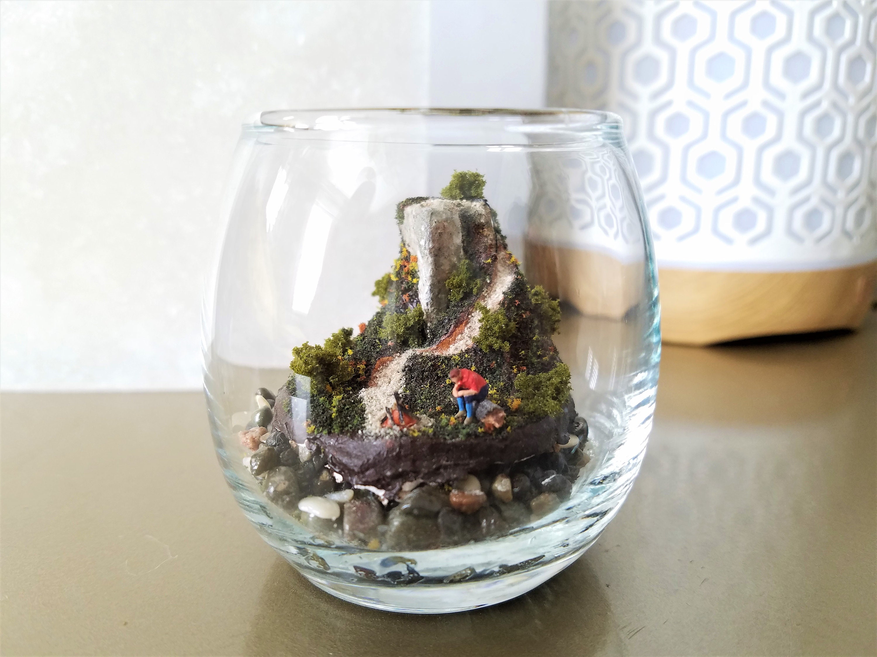 Man Sits On Glass Jar