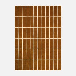 May include: A rectangular brown rug with a repeating pattern of vertical brown rectangles separated by white lines. The rug has a soft, textured appearance and is suitable for a living room or bedroom.