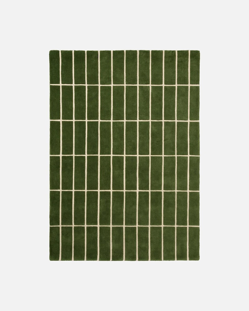 May include: A rectangular green rug with a repeating pattern of vertical green rectangles separated by thin, off-white lines. The rug has a soft, textured appearance and a simple, modern design.