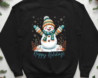 May include: Black sweatshirt featuring a cheerful snowman design. The snowman wears a hat, scarf, and mittens in teal, orange, and white. The words "Happy Holidays" are written in teal script below the snowman.