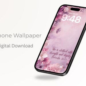 May include: A smartphone displays a floral phone wallpaper with a pink and purple color scheme. The lock screen shows the time and date. The text "She is clothed with strength and dignity Proverbs 31:25" is visible.