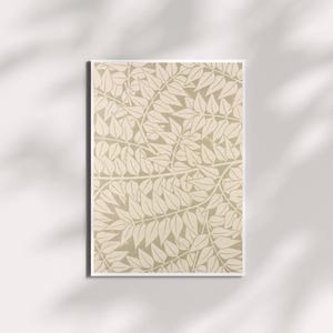 May include: A framed art print featuring a repeating pattern of stylized leaves in shades of beige and cream. The botanical design is set against a neutral background, creating a calming and natural aesthetic. The print is displayed on a white wall with shadows.