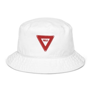 May include: White bucket hat with a red yield sign embroidered on the front.