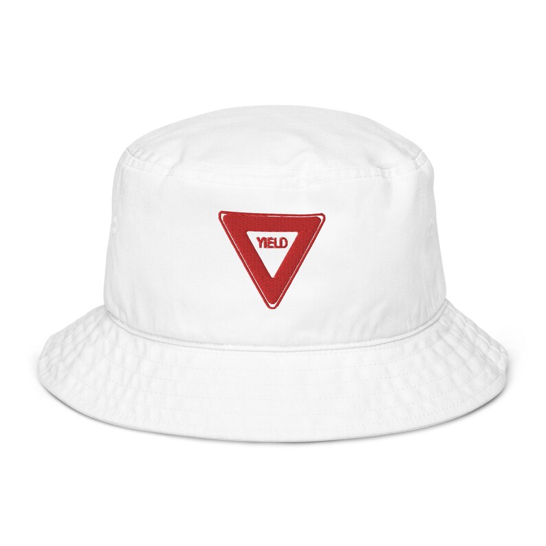 May include: White bucket hat with a red yield sign embroidered on the front.