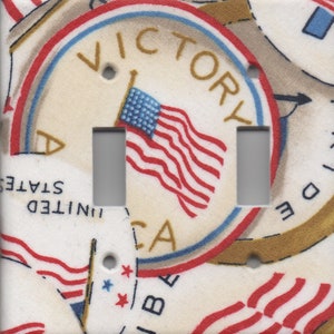 May include: A double light switch cover featuring a vintage patriotic design with an American flag and the words "Victory" and "United States of America".