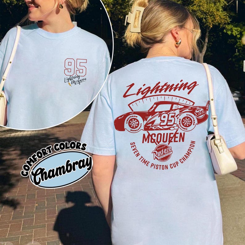 May include: Light blue t-shirt with a graphic of Lightning McQueen and the number 95. The front of the shirt has a small graphic with the number 95 and the text "Lightning McQueen". The back of the shirt features a larger design.