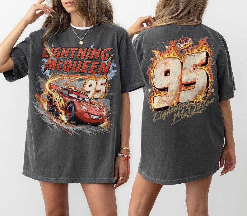 May include: Dark grey Lightning McQueen t-shirt with a graphic of the character and the number 95. The front design shows the red race car with flames, and the back has a large 95 with flames and the text "Lightning McQueen".