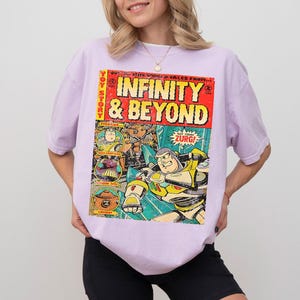 Puede incluir: Camiseta lila claro con un dise&ntilde;o de portada de c&oacute;mic. La portada presenta las palabras "INFINITY & BEYOND" en letras grandes. El c&oacute;mic tiene un fondo rojo y amarillo con im&aacute;genes de Buzz Lightyear y Zurg.