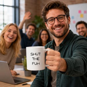 May include: A white ceramic mug featuring the black printed text SHUT THE FUH on the front. The mug has a standard cylindrical shape with a curved handle on the side, designed for holding hot or cold beverages in a home or office environment.