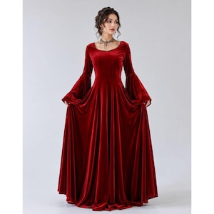 Gothic renaissance inspired red velvet gown with long bell sleeves and full floor-length skirt