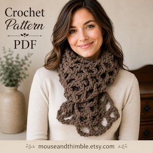 May include: A brown crochet scarf with an openwork pattern worn over a plain cream-colored long-sleeve shirt. The image includes the text Crochet Pattern PDF and the website address mouseandthimble.etsy.com printed on the image.