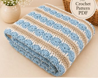 May include: A folded crochet blanket featuring alternating horizontal stripes of light blue, beige, and white yarn. The pattern includes textured circular motifs and simple stitch rows. A circular label in the corner reads Crochet Pattern PDF.