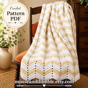 May include: A crochet pattern PDF featuring a chevron-striped blanket in alternating bands of white and soft yellow yarn. The blanket has a textured, open-stitch design with a wavy edge. Text on the image reads Crochet Pattern PDF and mouseandthimble.etsy.com.
