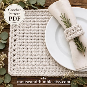 May include: A beige crochet placemat and a matching crochet napkin ring holding a light-coloured fabric napkin. The image includes text that reads Crochet Pattern PDF and mouseandthimble.etsy.com. The items are arranged on a dark wooden surface.