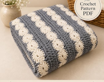 May include: A folded crochet blanket featuring alternating stripes of slate gray and cream yarn. The cream sections display a repeating circular floral motif, while the gray sections consist of solid rows. A circular label reads Crochet Pattern PDF.
