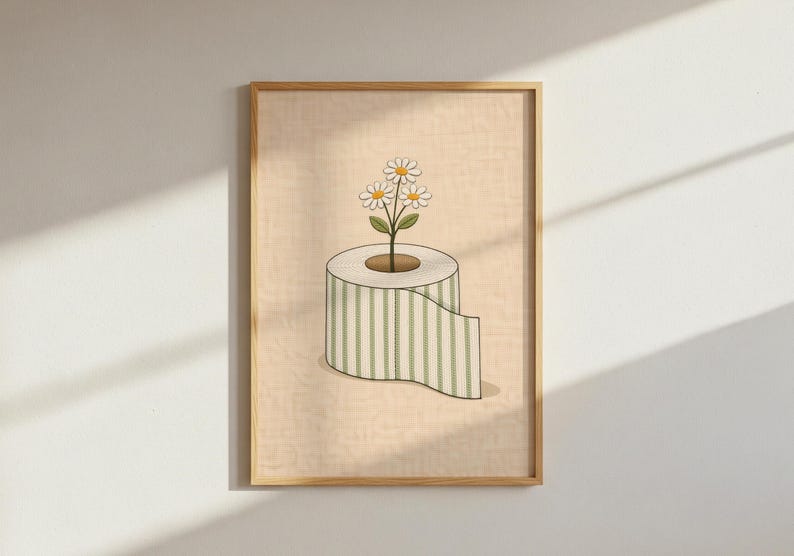 May include: A framed art print featuring a whimsical illustration. A roll of toilet paper with green and white stripes has a plant with three daisies growing from the center. The background is a light beige color.